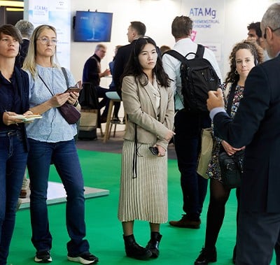 visitors listening to an exhibitor talking